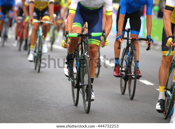 very fast cyclists pedal\
quickly through the streets of the city during the sporting event\
in europe