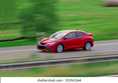 Very Fast Driving Red Japanese Modern Hatchback