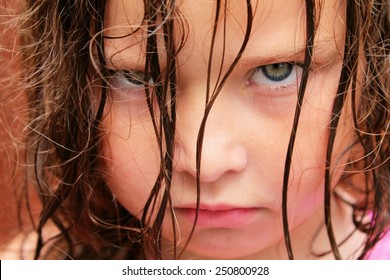  A Very Grumpy Young Girl With Green Eyes