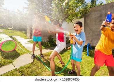 Very Happy Boy With Sprinkler In Water Gun Fight