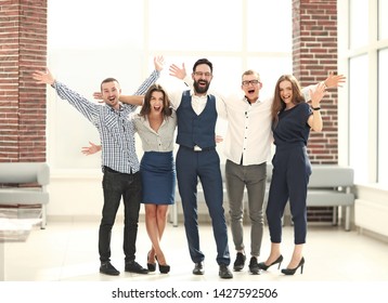 very happy business team standing in a bright office