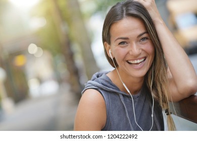 A Very Happy Young Woman Laughing In A City Setting