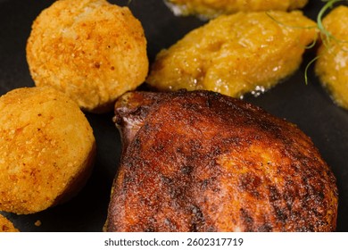 Very healthy roast duck thigh with potatoes and greens on a black plate on a wooden table serving in a restaurant. beautiful dish decoration