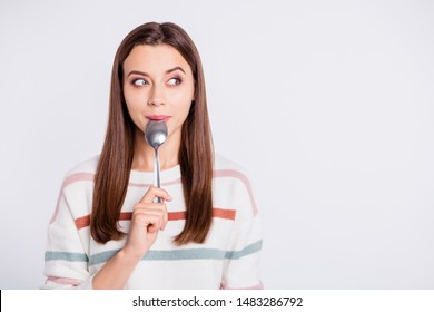 Very hungry lady holding spoon into mouth dream of tasty meal wear striped pullover isolated white background