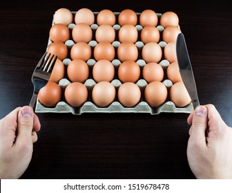 A Very Hungry Man Is Going To Eat A Whole Tray Of Eggs. Hungry Athlete After A Hard Workout Is Going To Eat Eggs. Eggs Are One Of The Main Sources Of Protein.