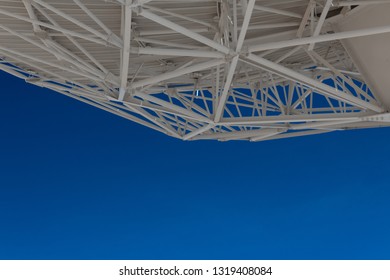 Very Large Array understructure of a large radio telescope dish with blue sky below, creative copy space, science technology, horizontal aspect