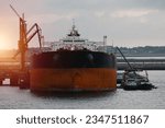 Very large crude oil carrier during loading and bunkering operations in the port. Crude oil tanker. International Trade Shipping.