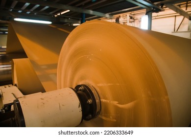A very large roll of paper is in production
