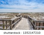 A very long boardwalk surrounded by shrubs in Perdido Key State Park, Florida