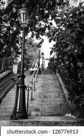 A Very Long Staircase With An Old Street Lamp In Montmartre, Paris, France. Black And White