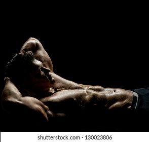 the very muscular sleeping sexy guy, lying on black background, naked  torso