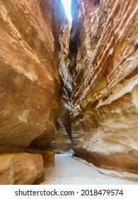 Very narrow walkway seek in rock crevices at Petra archaeological site in Jordan
