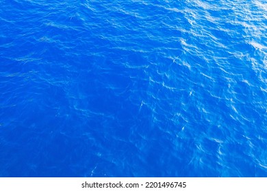 Very nice sea water background or backdrop with selective focus. Small waves of natural water surface texture. Still calm ripples colorful blue wave in a river or ocean. - Shutterstock ID 2201496745