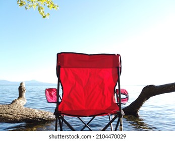 Very Nice View Of Lake Geneva Seated On A Red Chair