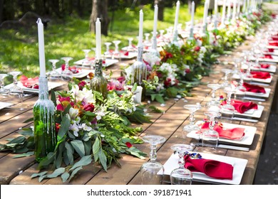 A very nicely decorated wedding table appointments with beautiful decor with plates and serviettes in spring garden. Beautiful flowers on table in wedding day. The elegant dinner table. - Powered by Shutterstock