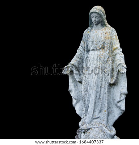 Very old and ancient stone statue of  Virgin Mary. Statue isolated on black background.