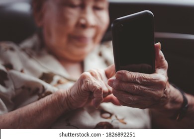 Very Old Asian Passenger Woman Age Between 80 - 90 Years Old Traveling By The Car While Raining And Using A Video Call. Cheerful Retired Woman In A Private Car Portrait With Copy Space.