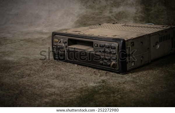 A very\
old car radio receiver with grunge\
background