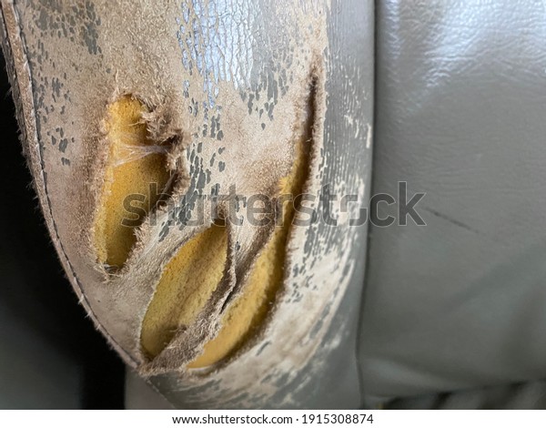 Very old car seat,\
artificial leather torn