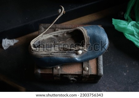 very old child shoe on a box