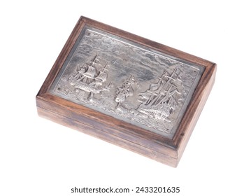 Very old cigarette case with a silver outside showing tall ships, isolated