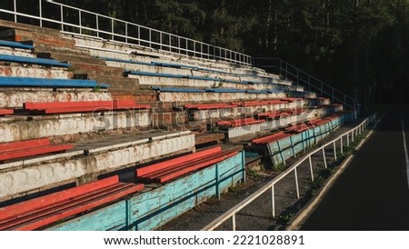 Very old dilapidated stadium stands of the city stadium. Summer sunny day
