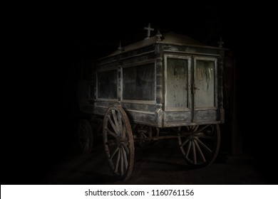 Very Old And Dusty Hearse Stage Made Of Wood, With Large Wooden Wheels. Used To Transport The Coffin With The Dead During The Funeral In The Late 18-th Century.