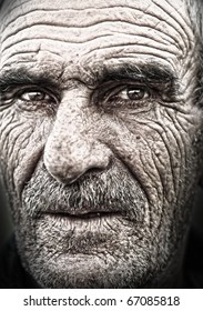 Very Old Face - Very Old Photo. Portrait, Elderly Man With Huge Wrinkles On Face. Some Grain Added.