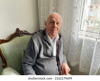 Very Old Man Boomer Portrait With Emotions. Grandfather Is Smiling And Looking To Camera. Portrait- Aged, Elderly, Senior. Close-up Of Old Man Sitting In His Living Room. Father's Day Concept.