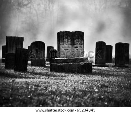 Very old misty and creepy graveyard in black and white