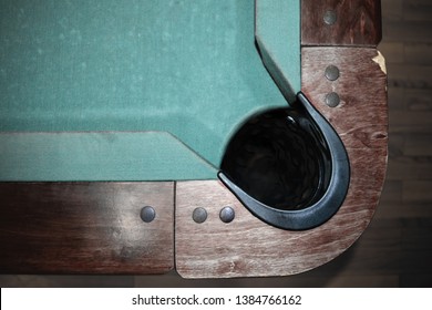 Very old part of green with wooden edges and black ball hole pool table background