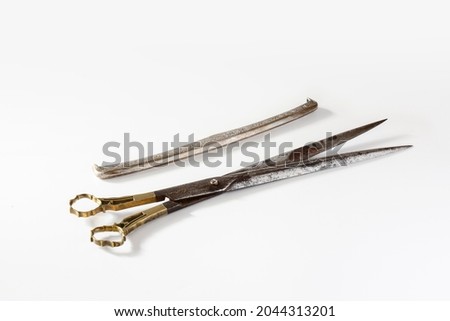 very old and rusty tailor's scissors and case. isolated white background