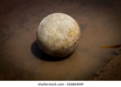 Very Old Soccer Ball On The Water 