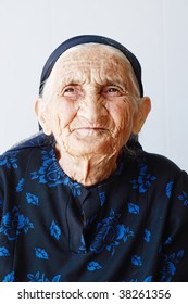 Very Old Woman Closeup Portrait Against Light Background