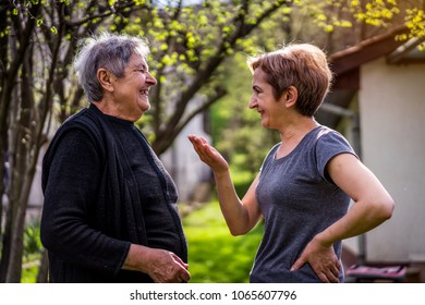 Very Old Woman With Her Daughter Smiling And Laughing