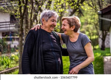 Very Old Woman With Her Daughter Smiling And Laughing