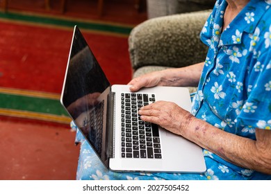 Very Old Woman Using Laptop Sitting In Her Sofa