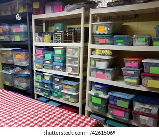 A Very Organized Craft Room With Lots Of Containers.