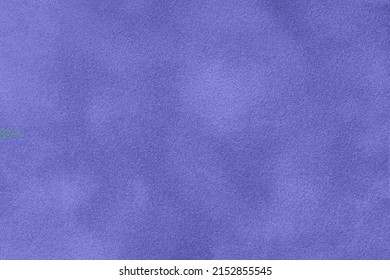 Very peri matte background of suede fabric, macro. Velvet texture of seamless navy blue leather. Texture of textile backdrop, macro. Color of the year 2022.