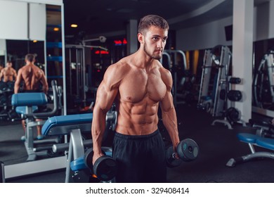 Very Power Athletic Guy Bodybuilder , Execute Exercise With Dumbbells