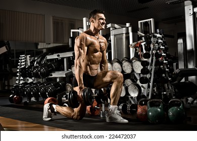 Very Power Athletic Guy ,  Execute Exercise With  Dumbbells, In Gym