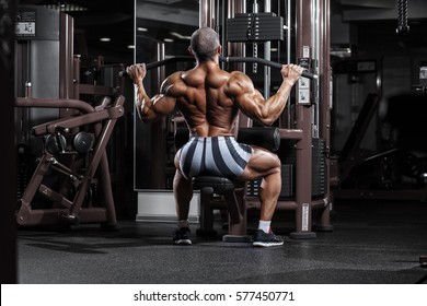 Very Power Athletic Guy Training Back Workout In The Gym.