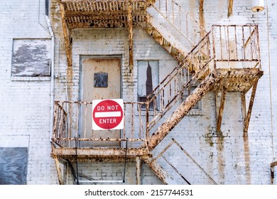 Very Rusty Exterior Stairwell On A Building With A Do Not Enter Sign