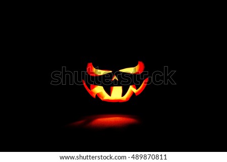 Similar – Image, Stock Photo Creepy carved Halloween pumpkin next to burning candle