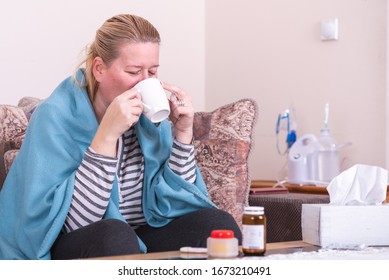 A Very Sick Woman With Temperature Drinks Warm Tea