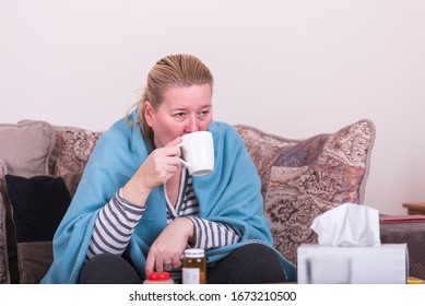 A Very Sick Woman With Temperature Drinks Warm Tea