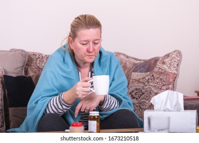 A Very Sick Woman With Temperature Drinks Warm Tea