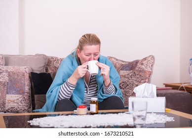 A Very Sick Woman With Temperature Drinks Warm Tea