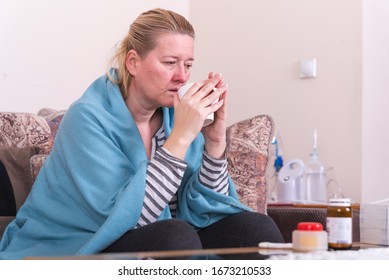 A Very Sick Woman With Temperature Drinks Warm Tea