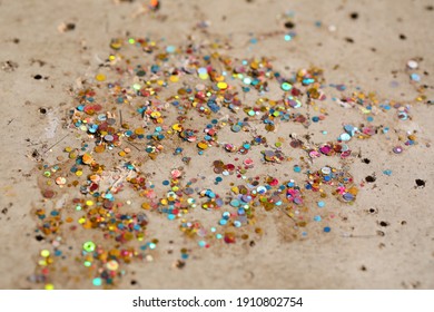 Very small multicolored plastic panels placed on a cement floor.